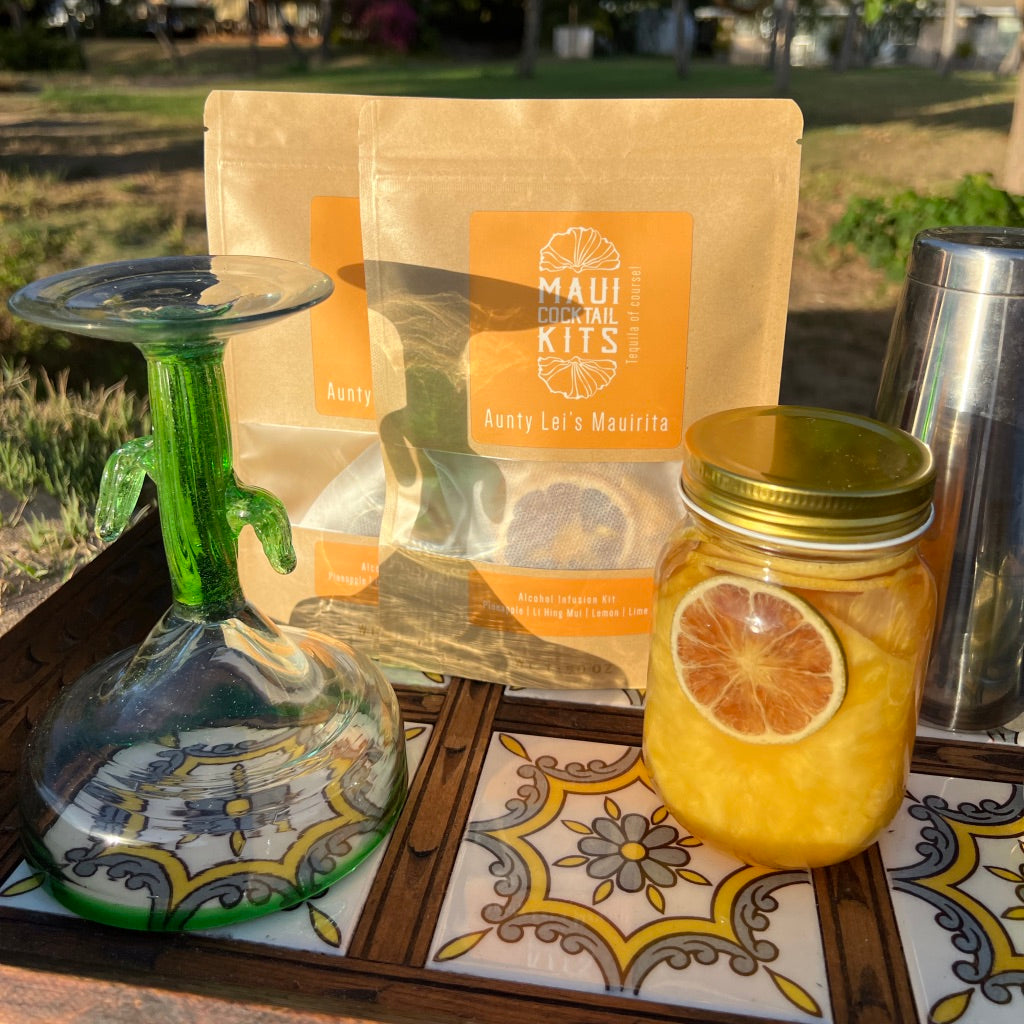 A tray with Maui Cocktail Kits diy tropical cocktail kit and a freshly prepared cocktail