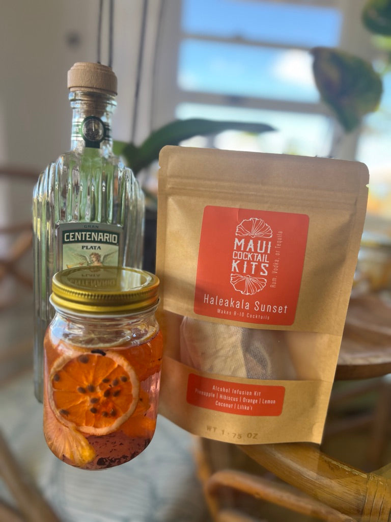 Bottle of Centenario Plata rum, jar with orange slices, and Maui Cocktail Kits Haleakala Sunset for tropical rum cocktails
