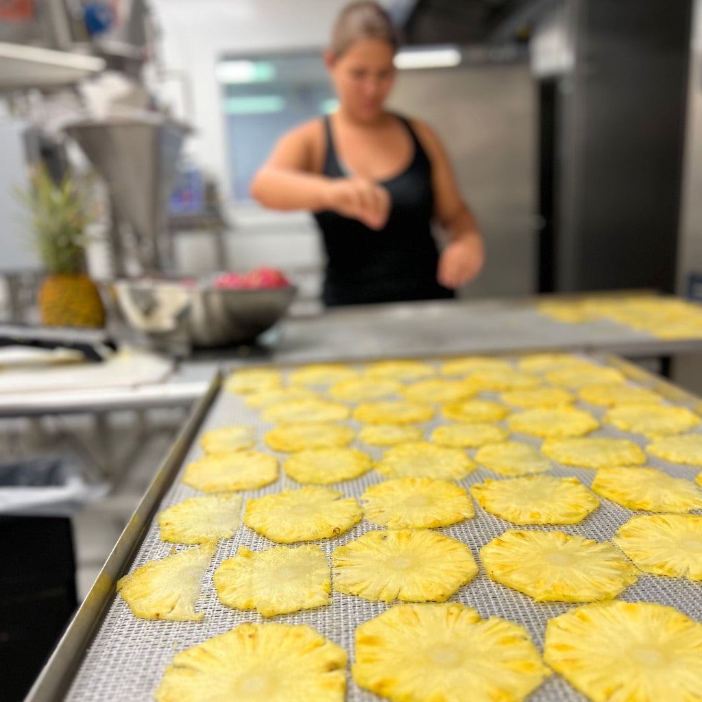 A tray full of dried pineapples for all natural Maui Cocktail Kits